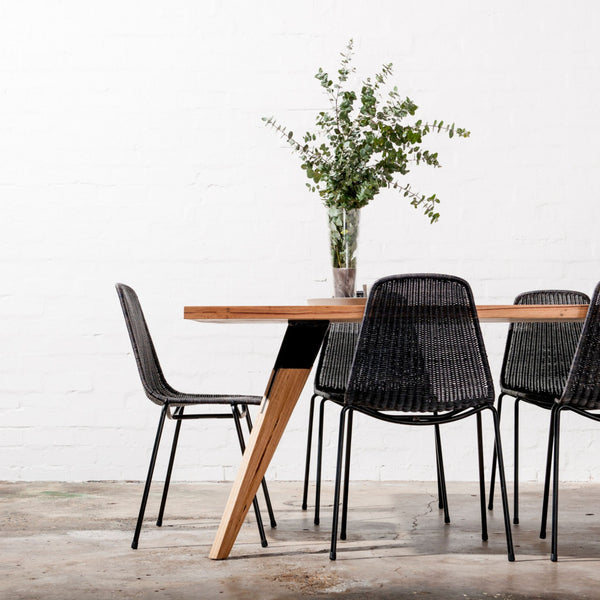 Custom made dining table in messmate with angled and tapered legs. Black metal feature in the legs. Made in Torquay victoria. 